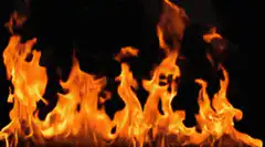 Orange flames burning against black background