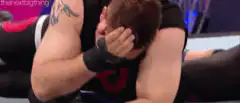 Wrestler facepalms on mat