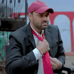 Man loosens red tie and looks tired