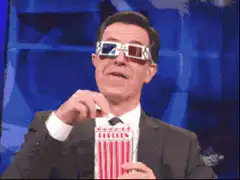 Stephen Colbert eating popcorn with 3D glasses