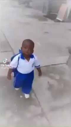 Toddler in school uniform walking