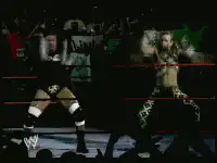 WWE wrestlers pose with pyrotechnics