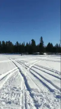 Snowmobile rider drifting in snow