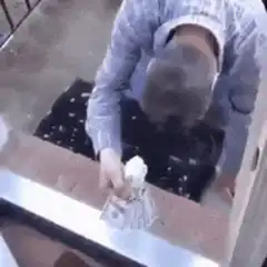 Man hiding money under doormat