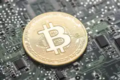 Bitcoin coin on circuit board