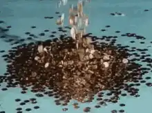 coffee beans falling into pile