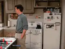 Ross and Chandler hug in the kitchen