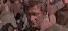 John Wayne grimacing in a movie
