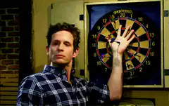 Gavin Belson holding hand up to dartboard