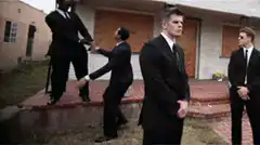 Men in Black dancing in background