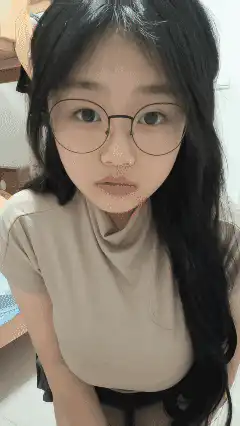 Girl with glasses looking down then up