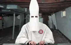 Ku Klux Klan member raises fist