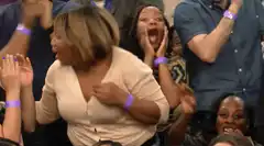 Audience members react with shock and excitement