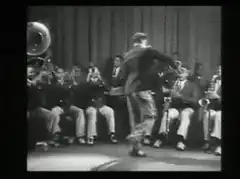 Man tap dancing with band