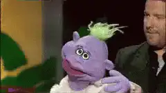 Purple puppet with green hair