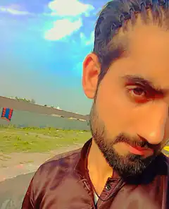 Man with braided hair looking at camera