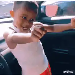 Young boy dabbing in car