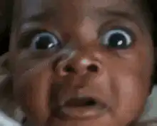 Baby with wide shocked eyes