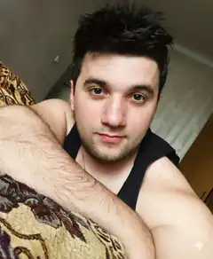 man in black tank top selfie