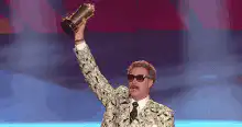 Will Ferrell as Ron Burgundy holding trophy