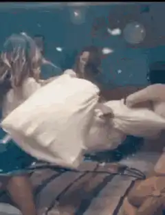 Two women having a pillow fight