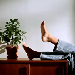 Person resting feet on dresser