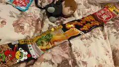 Japanese snack packages on floral bedspread