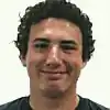 Man with curly hair smiling
