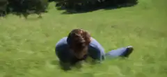 Man rolling on grass