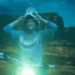 Cale holding a shark head with laser eyes