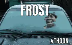 Woman laughing behind frosted car window