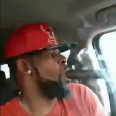 Man smoking cigar in car