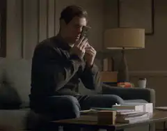 Man kissing phone in relief