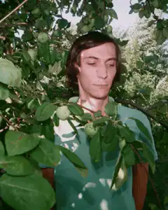 John Lennon in apple orchard