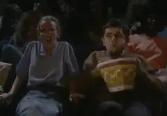 Man spills popcorn in movie theater