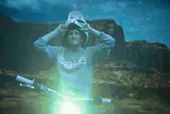 Man with glowing eyes and cake shirt