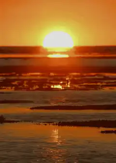 sunset over water with clouds