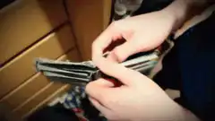 Guy opens empty wallet and reacts