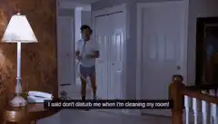 Man cleaning room with vacuum on phone