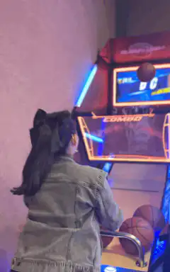 Girl playing basketball arcade game