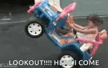 Toddler in toy jeep doing a wheelie