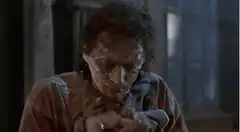 Man pulls long white string from mouth