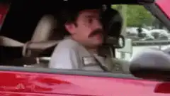 Ron Swanson sinks into car seat