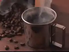 Steaming metal coffee mug