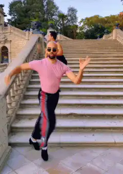 Two men dancing on stone stairs