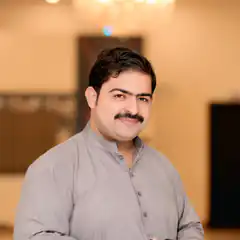 Man in grey kurta smiling