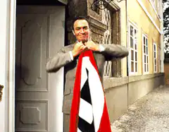 Man tears Nazi flag in half
