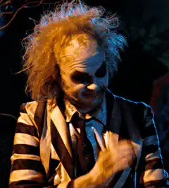 Beetlejuice looking down and smiling