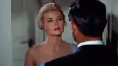 Grace Kelly kisses man on cheek