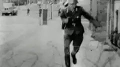 Soldier running down street